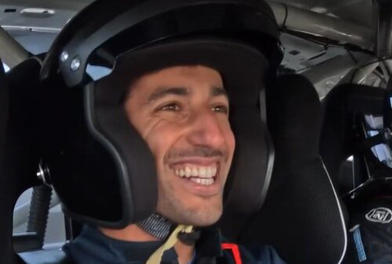 Daniel Ricciardo smiling with a helmet on