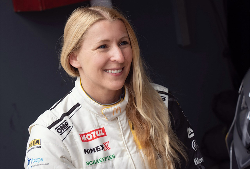 Pippa Mann in her race suit smiling in a candid shot
